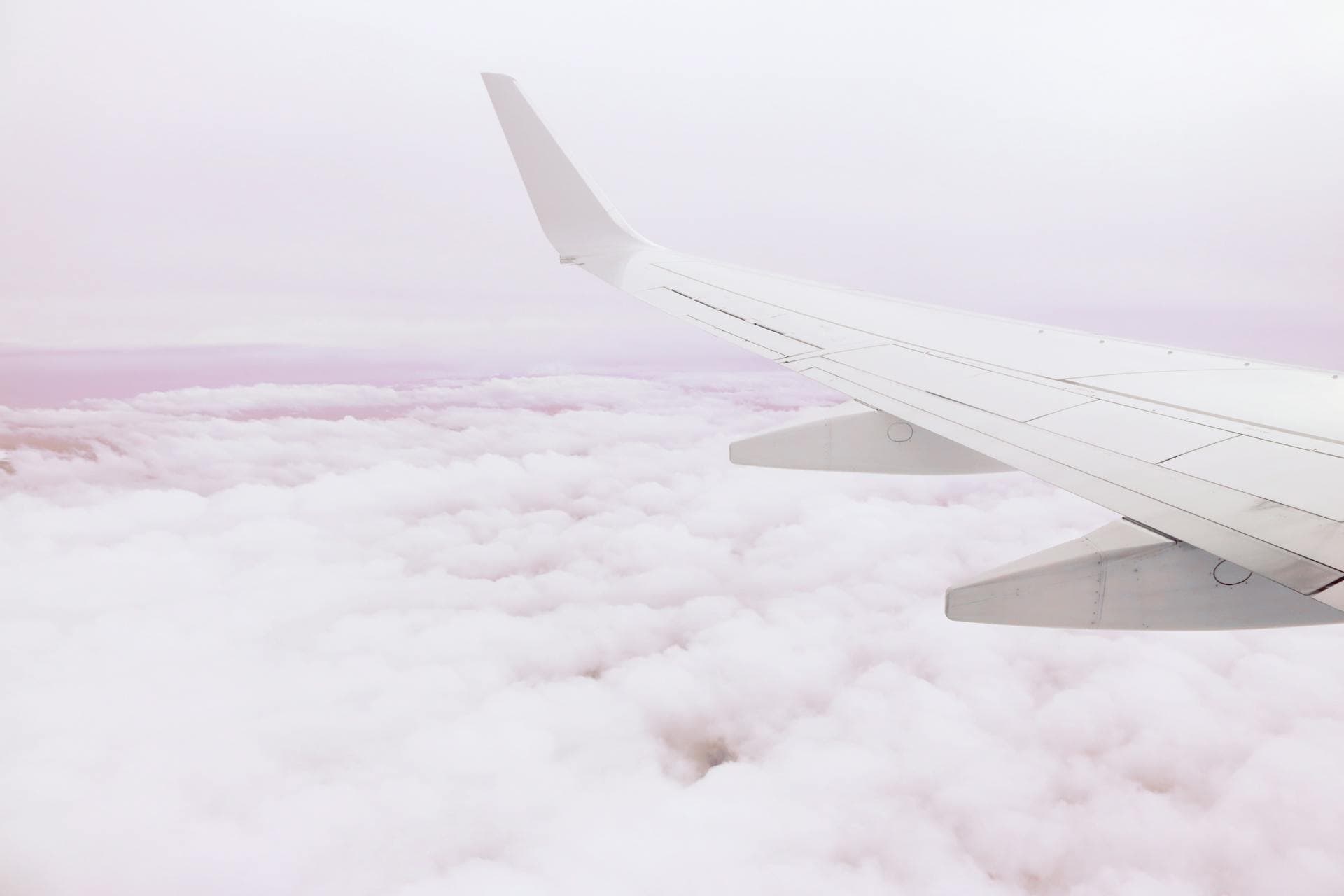 An aircraft wing soaring above the clouds en route to Colombo