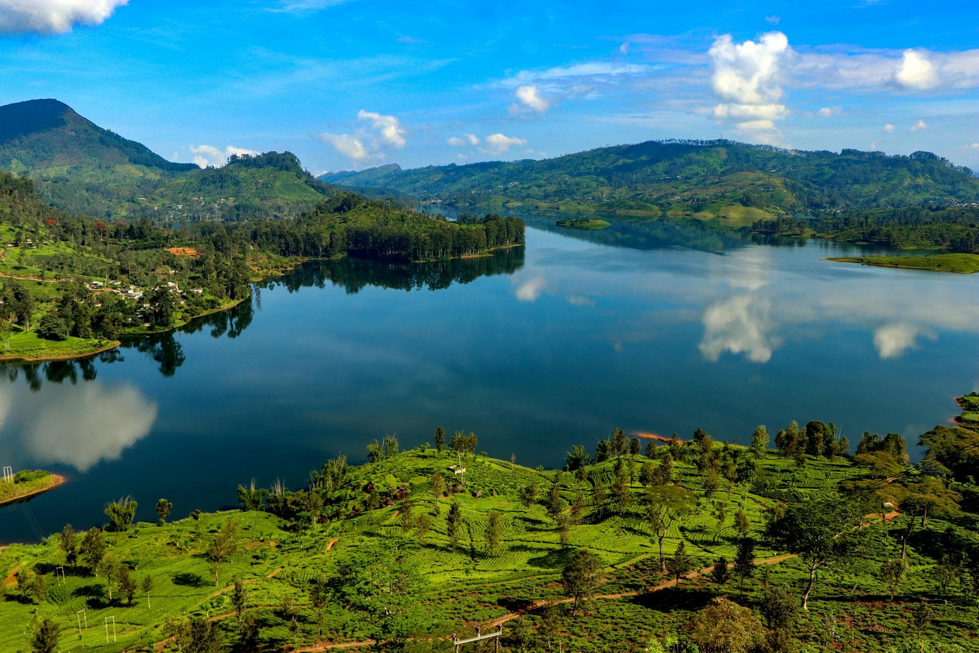 A tranquil lake beneath the tea-clad hills of Sri Lanka